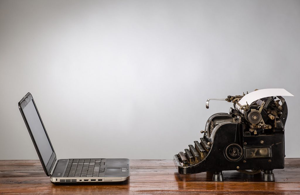 Change is Inevitable - laptop next to typewriter