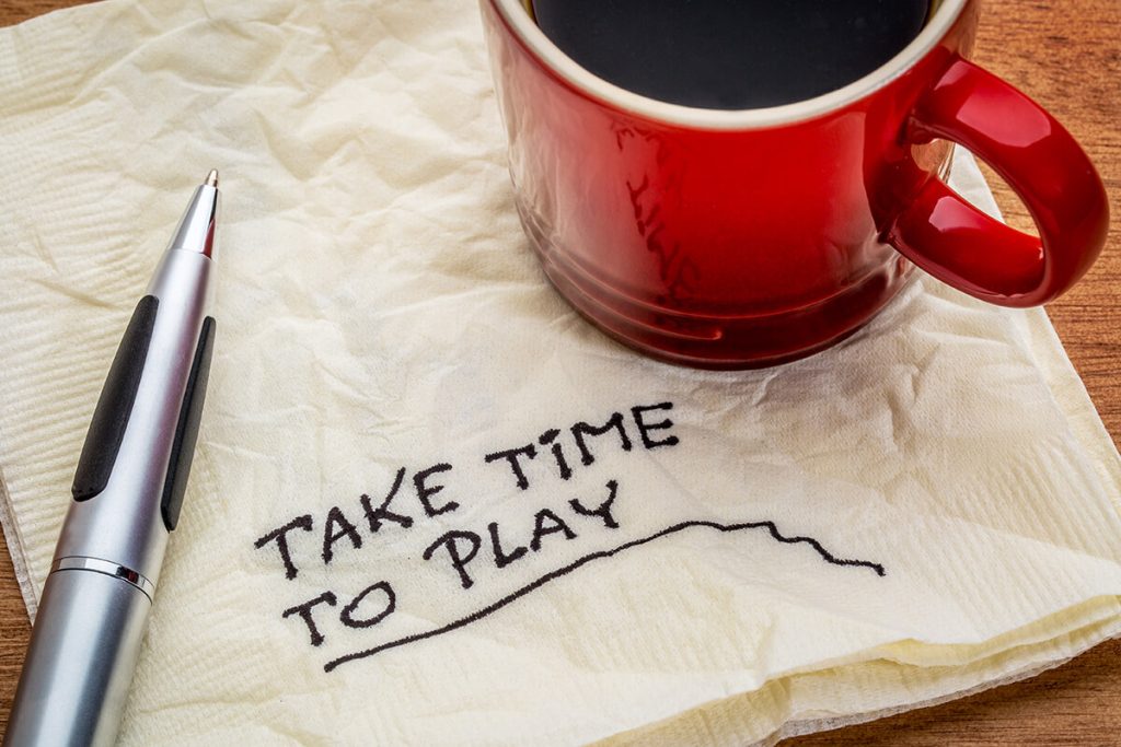 Take time to play advice on napkin next to a cup of coffee